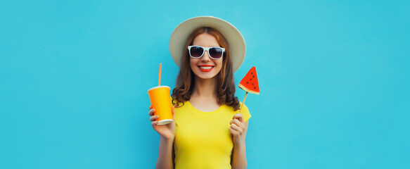 Summer portrait of happy woman with cup of juice and sweet lollipop watermelon on blue background