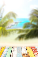 Blank wooden table top on blurred tropical seascape background. Wood terrace flooring and ocean beach. Tropical resort. Summer time concept. Relaxing on sea cost