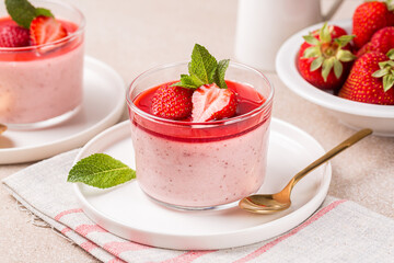 Strawberry panna cotta made with roasted strawberries, delicious, creamy dessert with sauce and fresh berries. Homemade.