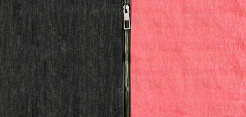 Pink and black denim background with zipper. Coral and dark gray color denim jeans fabric texture...