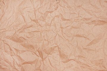 Wrinkled texture of crumpled brown craft paper as background