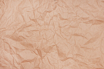 Fototapeta premium Wrinkled texture of crumpled brown craft paper as background