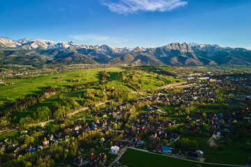 Aerial view of Tatra mountains and Zakopane town at sunset. Panoramic landscape with mountain...