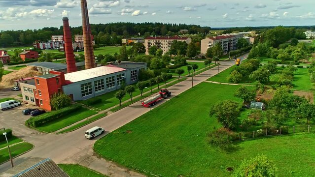 Aerial view of a city with industrial chimneys in the background