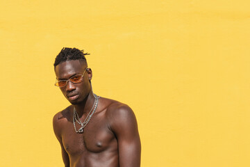 Portrait Of A Young Cool Man Over Yellow Background