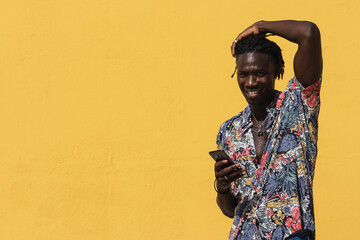 Portrait of handsome black man using his mobile.