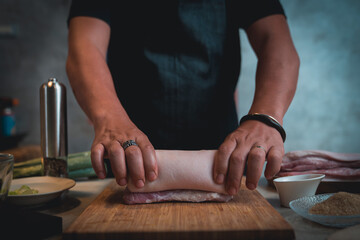 Men tie ropes and cut pork to make Japanese-style pork slices.