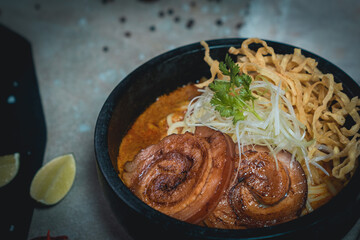 Khao Soi, a local dish of northern Thailand, is filled with various spices including lime, shallots, and chili.