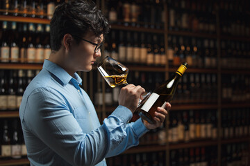 Professional Sommelier Evaluating Wine With Intense Focus In Cellar Setting