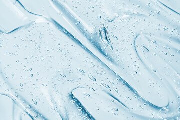 Gel serum texture. Blue liquid skincare background. Transparent beauty product with bubbles closeup