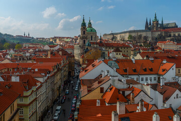 Fototapeta premium Church of St. Nicholas (built 1732-1737) against the backdrop of the roofs of the capital of the Czech Republic - the city of Prague