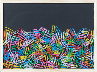 Fototapeta premium Black board with colorful paper clips and copy space