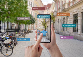 Tourist information and signposts on smart phone in tourist hands. The concept of using augmented...