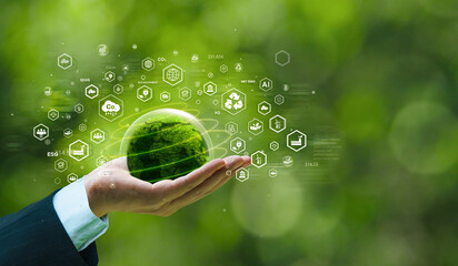 Businessman's hand holds green planet with ESG, net zero, carbon co2 and net zero icons. environmentally friendly carbon saves our planet, world environment day, earth day and climate change