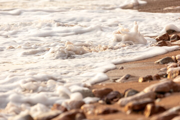 Pebble stones on the shore close up background