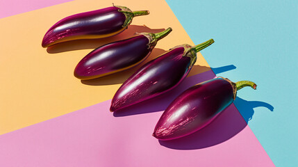 Composition with fresh eggplants on color background -