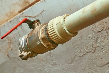 Plumbing. Sewerage. Water valve shutting off the water tap in the basement