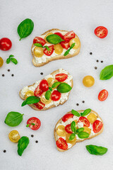 Fresh bread sandwiches with tomato cherry, cream cheese and basil leaves. Morning breakfast concept