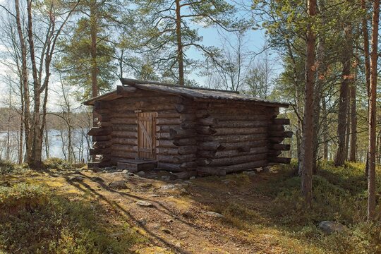 Logging cabin at Nellim log flum in sunny spring weaher with clouds in the sky, Nellim, Inari, Lapland, Finland.