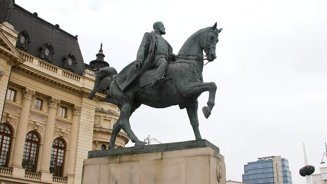 Equestrian Carol I of Romania statue, ahistorical figure in front of an ornate building, cloudy day in Bucharest, Romania