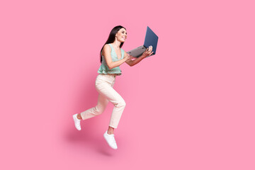 Photo of adorable funny nice woman dressed stylish clothes reading netbook device isolated on pink color background