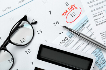 Tax day. Calendar with date reminder, documents, pen, glasses and calculator on table, flat lay