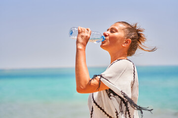 Picture of woman drinking water in warm day in Egypt