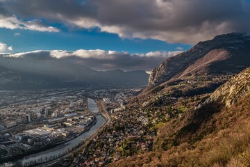 the sun is setting on this mountain valley near the city