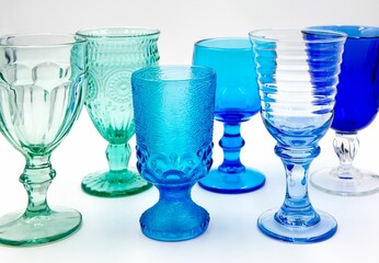 Set of blue glasses, elegantly placed on a white table in the foreground of the image