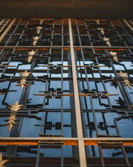 Metallic grille in a building interior, with a multitude of stars visible through the grille