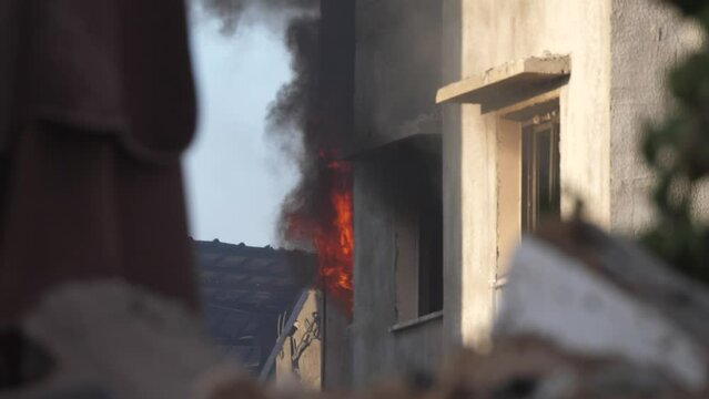 Bombed building massive fire smoke after missile attack explosion when Israel bombs Gaza killing Palestinians 