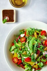 a white bowl filled with salad and sauce on top of a table