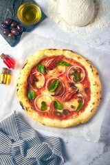 a homemade pizza sitting on top of a white tablecloth