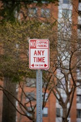 a street sign indicating no stopping parking any time to turn