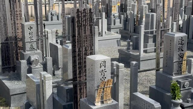 Stone shrines with etchings and offerings respecting ancestors at Genkō-an Temple Kyoto Japan.