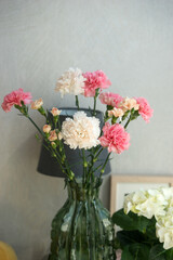Bouquet of pink and white carnations in a vase