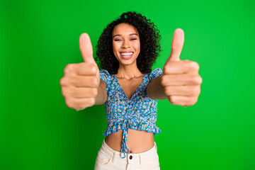 Photo of lovely young lady show thumb up you wear top isolated on green color background