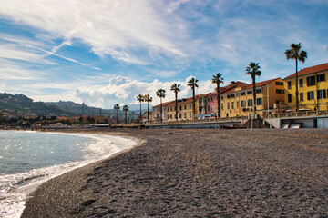 view on houses at the beach with palms in foreground