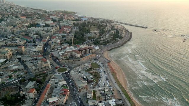 Drone footage over Old Jaffa with Alma Beach and Jaffa Port in Israel at sunset