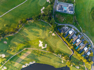 Aerial view of beautiful green golf field fairway and putting green, Top down image for sport...