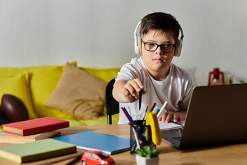 adorable boy with Down syndrome sitting at a desk, interacting with a laptop.