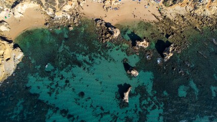 the blue water is so clear on the beach as if not in the sun