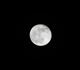 Full moon is visible in the night sky, illuminated by the light of the stars