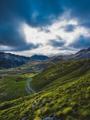 Aerial view of a lush valley, highlighted by a winding road in Balkan mountains in Montenegro