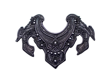 Obraz premium Intricate medieval armor neck guard with detailed engravings and patterns, showcasing historical craftsmanship and design.