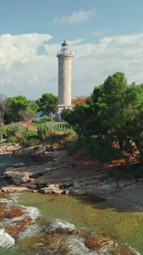 Savudija lighthouse on the Adriatic sea coast, the westernmost point of the Balkans peninsula and the oldest lighthouse in Croatia. Aerial drone view of the Croatian coast with a historic lighthouse