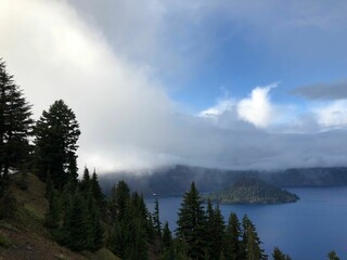 Stunning view of a calm lake surrounded by dense green trees