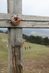 Intricately carved wooden cross adorned with a bird's nest creating a stunning visual effect