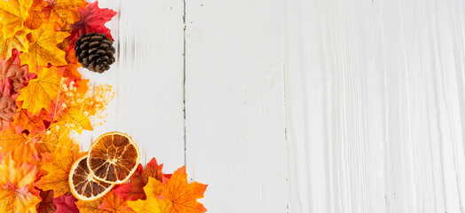 Autumn season and yellowing leaves on wooden background