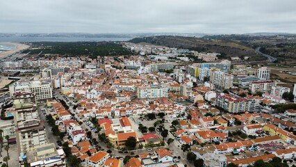 Aerial view of a scenic view of a sunny beach with coastal buildings on the sandy shoreline